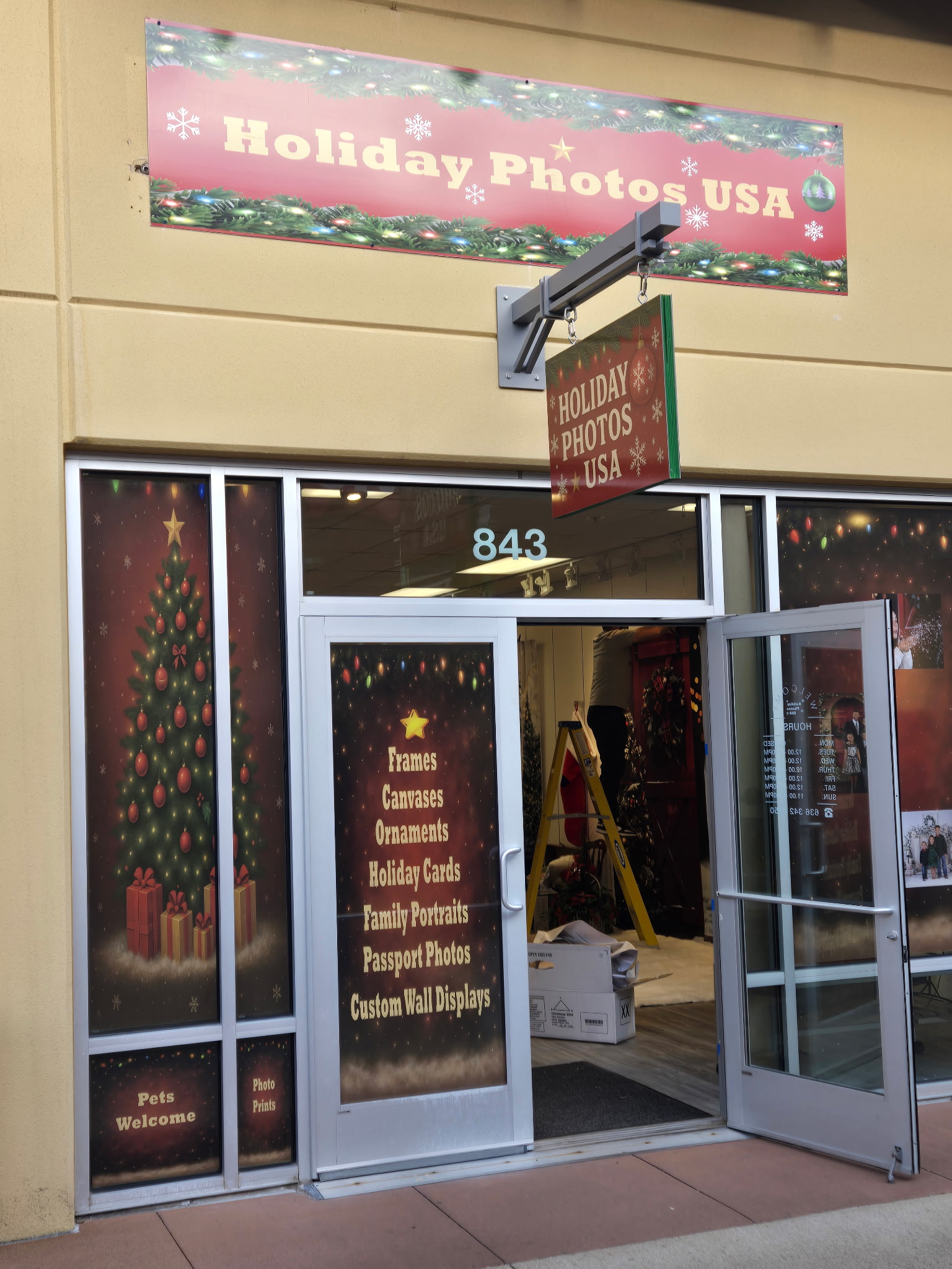 Hanging business sign with window decals